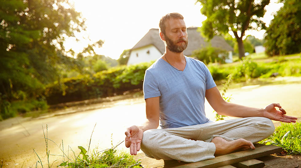 Breathing for mental and physical wellbeing; man meditating